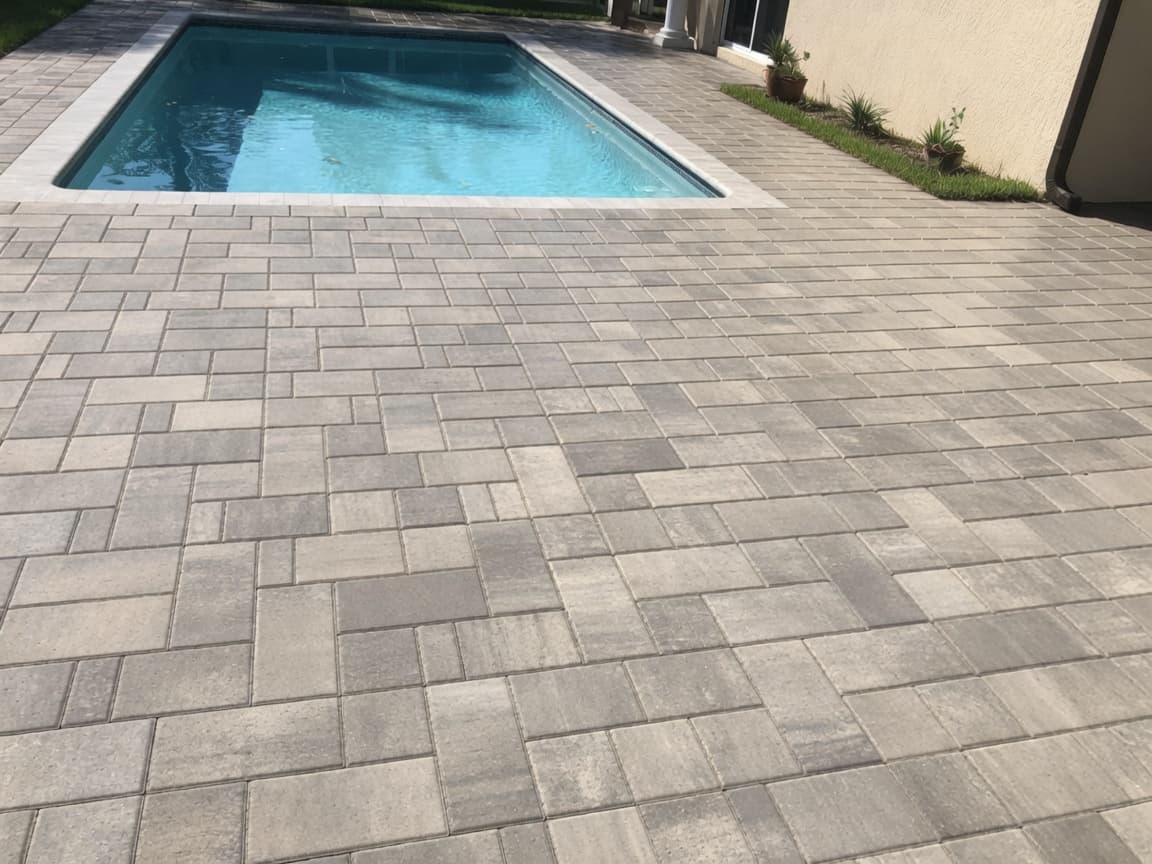 Pool deck — multi-size before modern paver sealing — dry matte multi-tone surface
