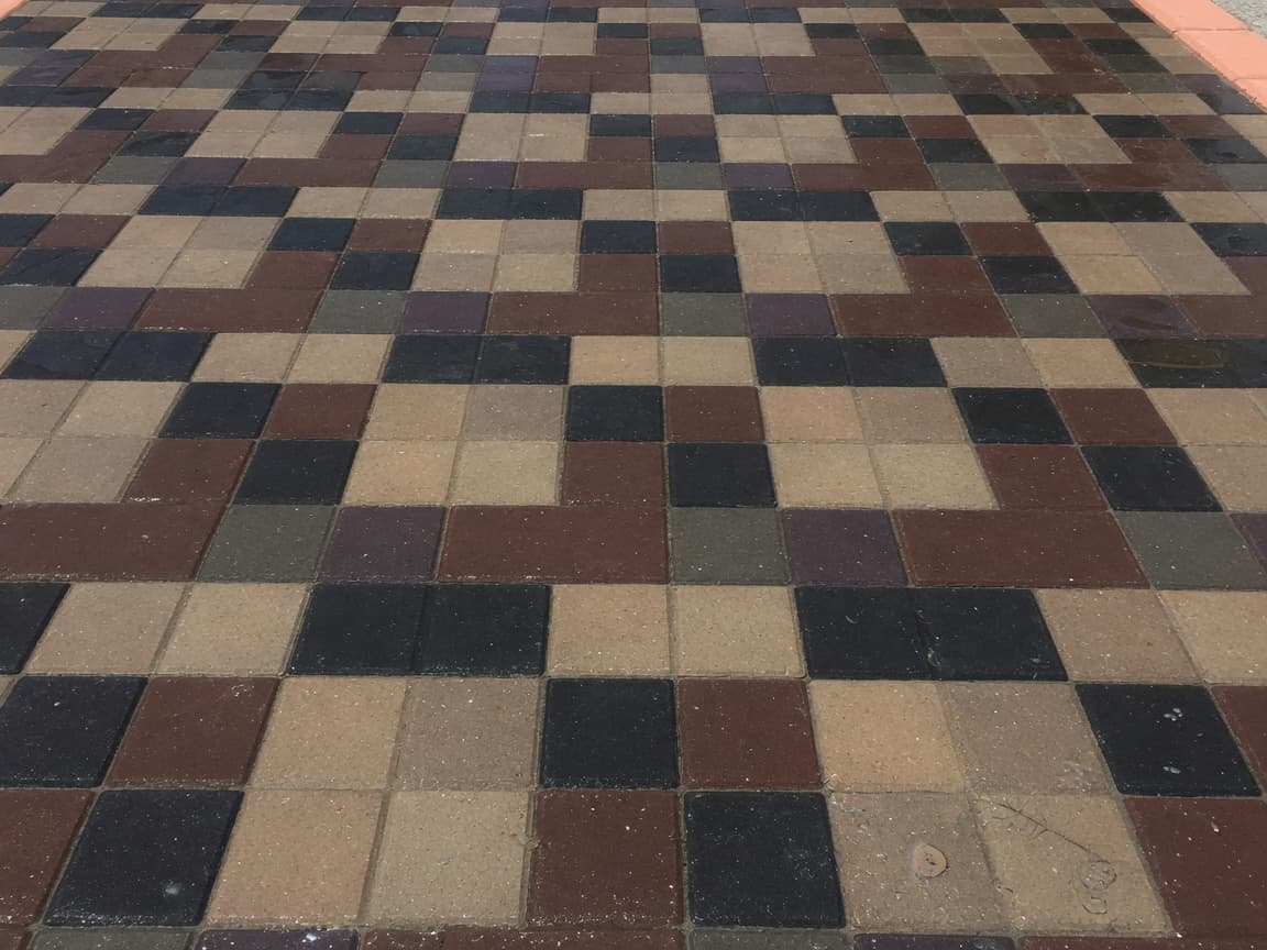 Surface detail after wet-look sealing — rich multi-tone color and soft sheen