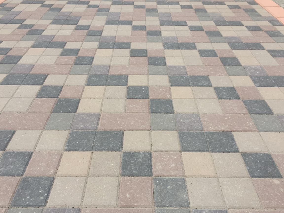 Surface detail before modern paver sealing — dry matte multi-tone surface